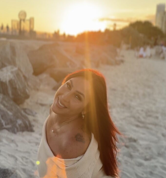 Icielani looking toward the camera on a beach at sunset. Artist-supplied campaign photograph.